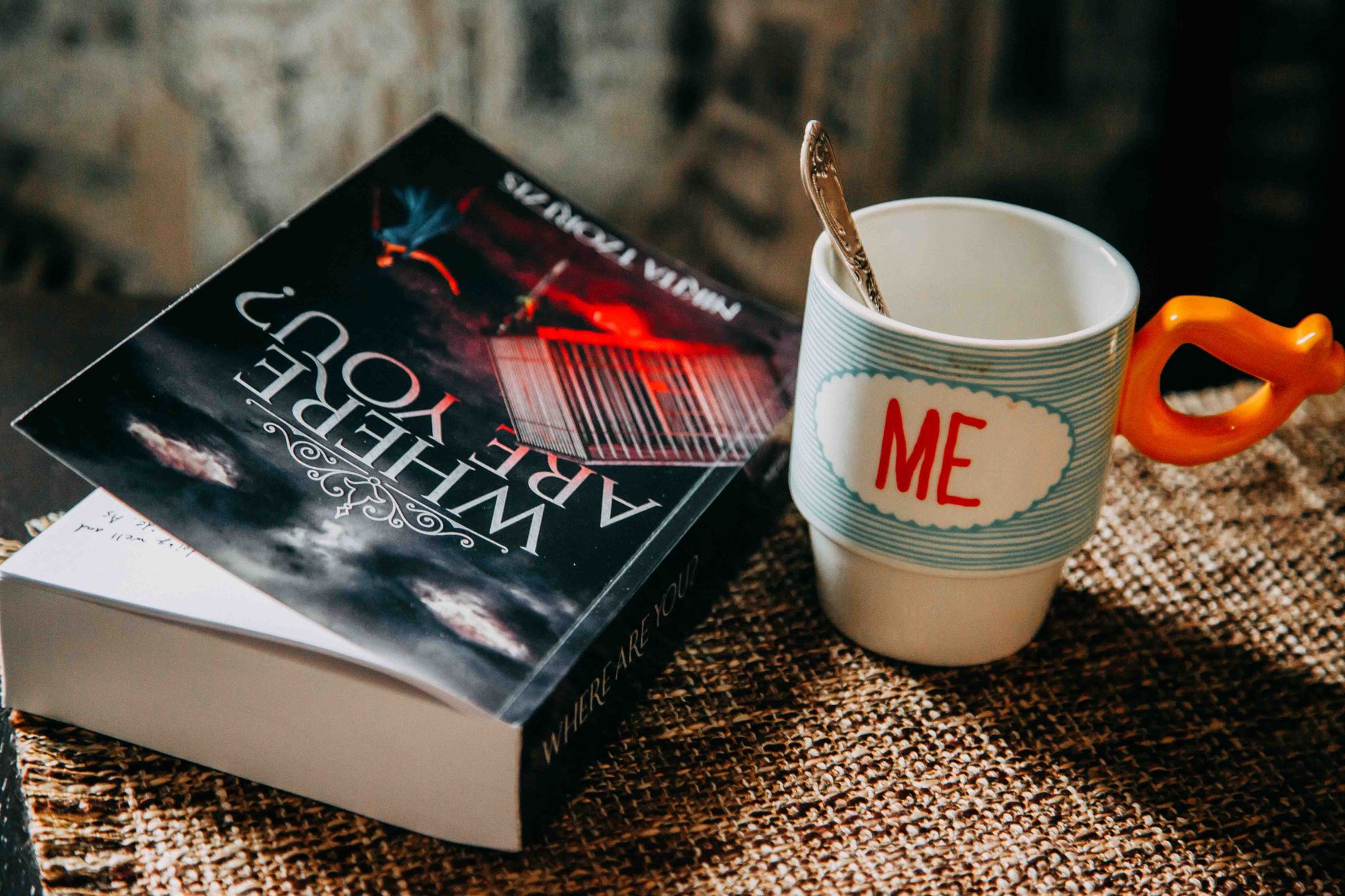 A cozy setup with a book and cup preparing for a relaxing morning.