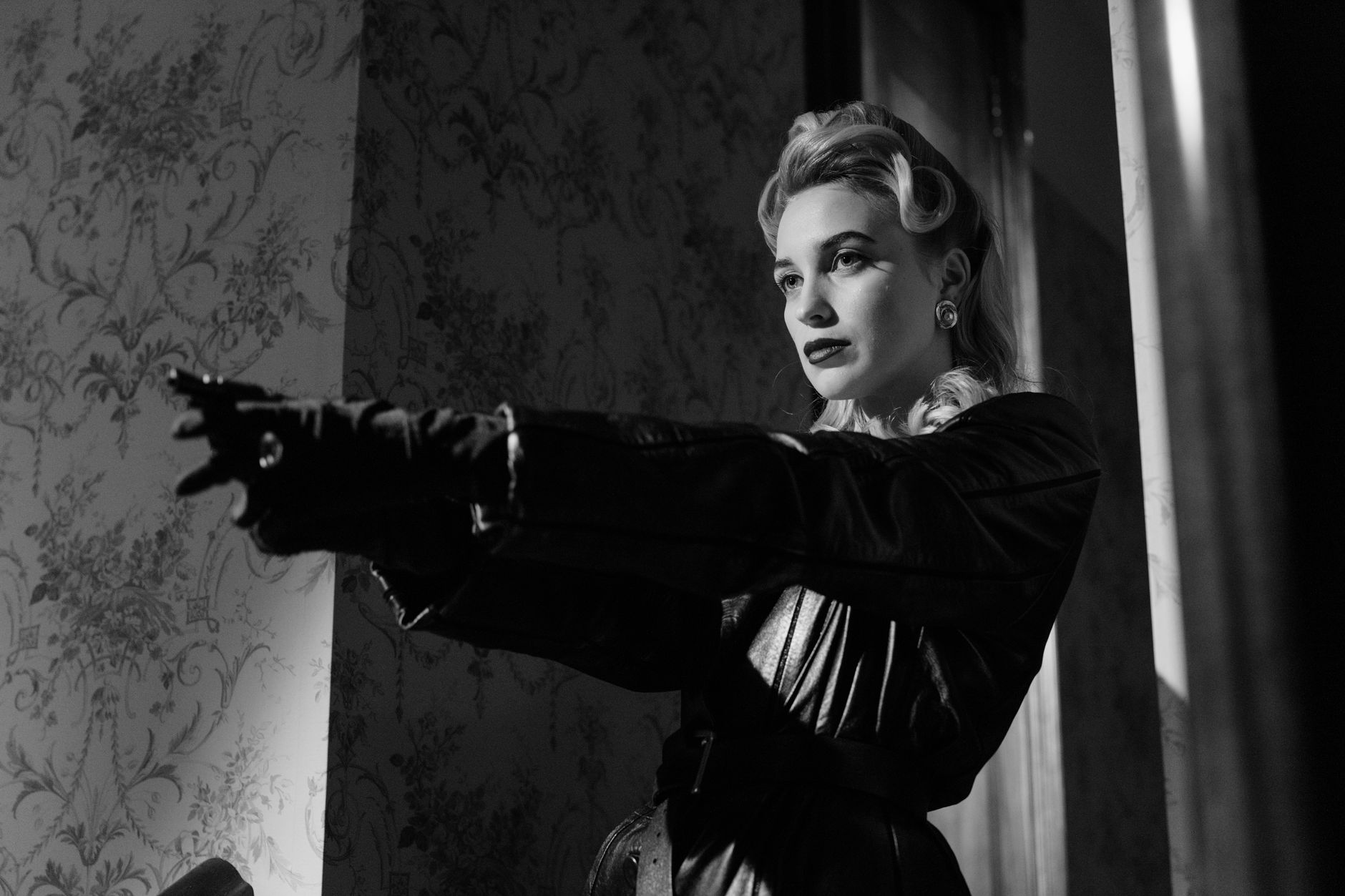 Cinematic black and white portrait of a mysterious femme fatale in vintage style.