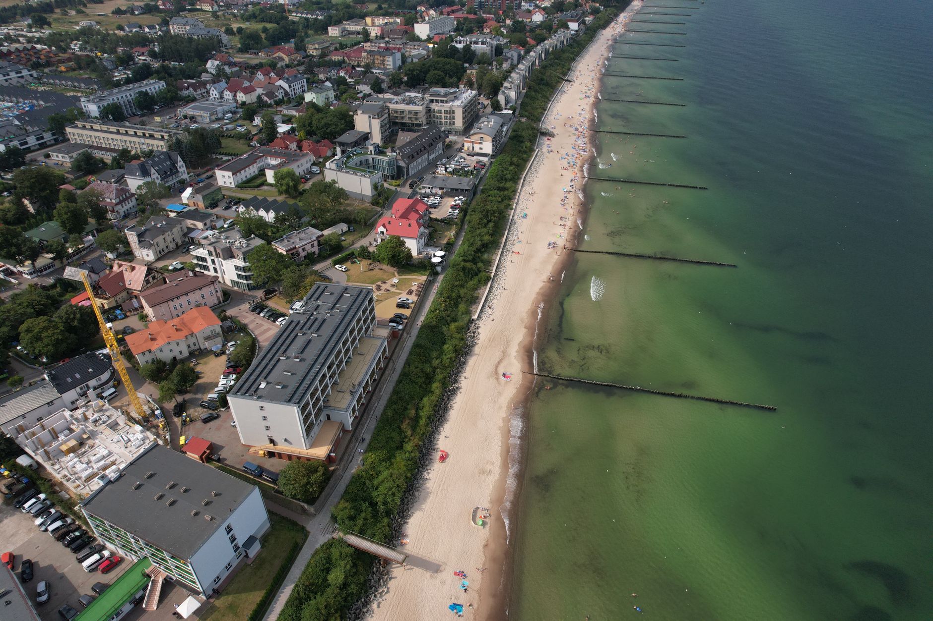 Drone shot of Ustronie Morskie beach and coastal town in Poland.