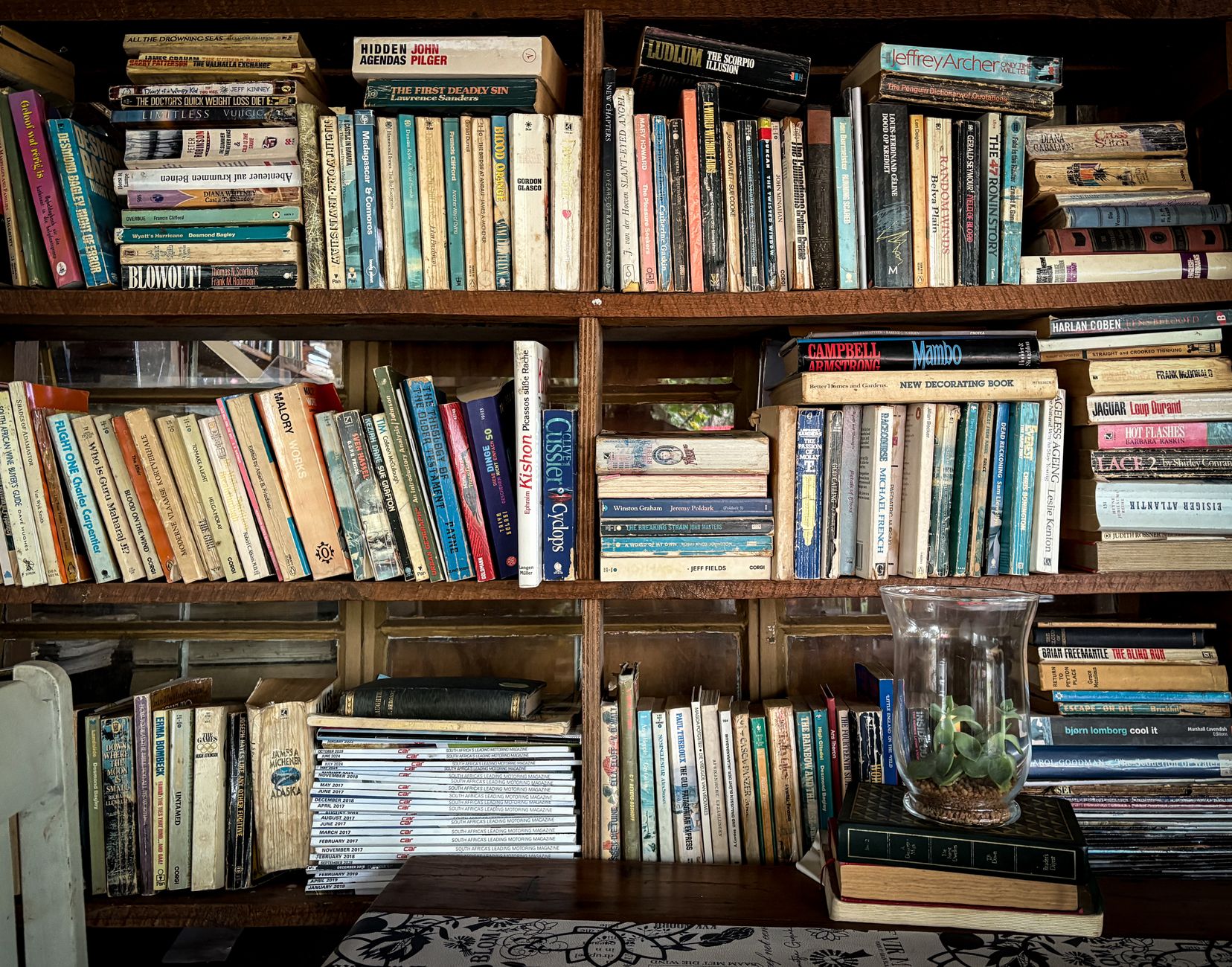 Vintage bookshelf packed with diverse books, offering a cozy and intellectual atmosphere for readers.