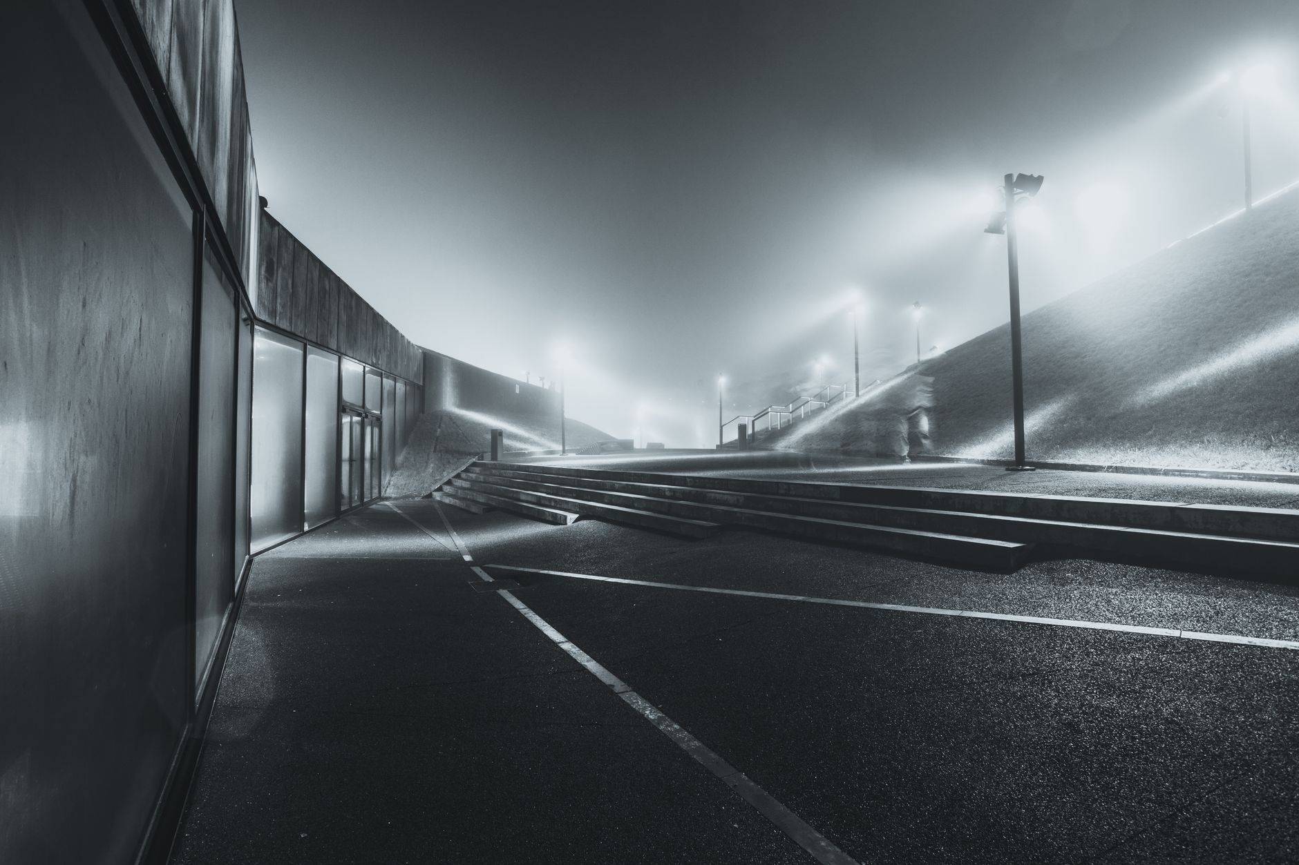 Captivating night view of modern architectural landscape in Katowice, Poland, with dramatic lighting and mist.